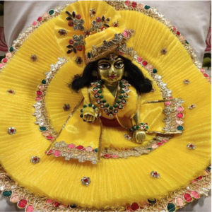 yellow–orange festive laddu gopal poshak with decorative borde